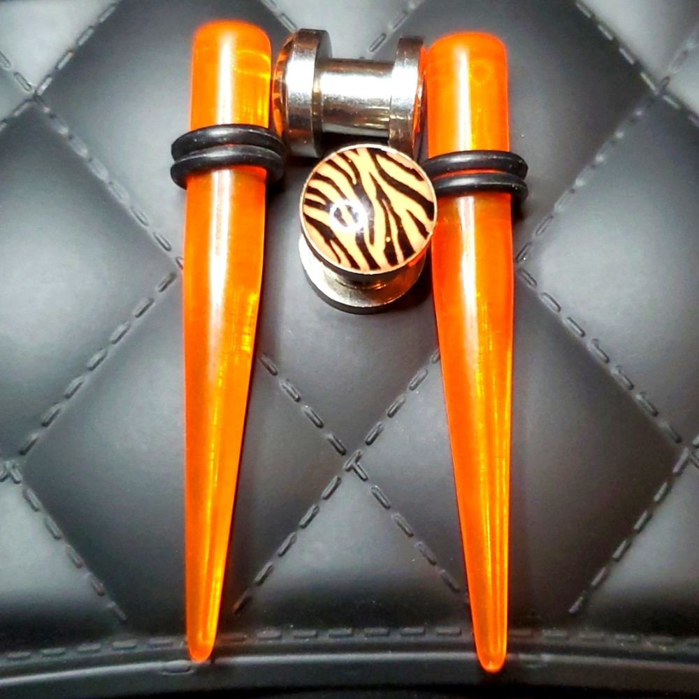 Orange translucent Tapers and zebra print ear plugs stainless steel 2 gauge